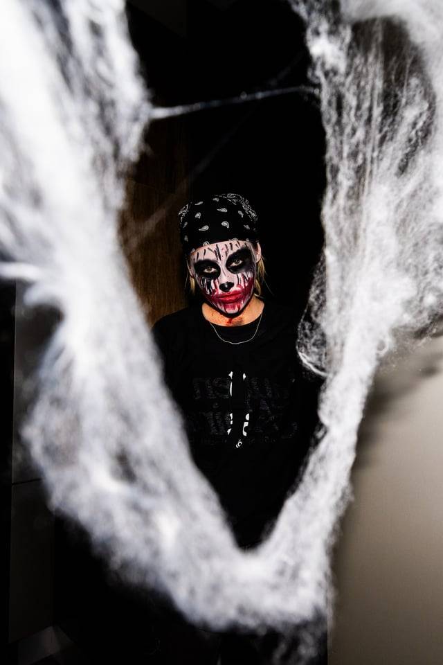 Zombie staring at camera thru cobweb